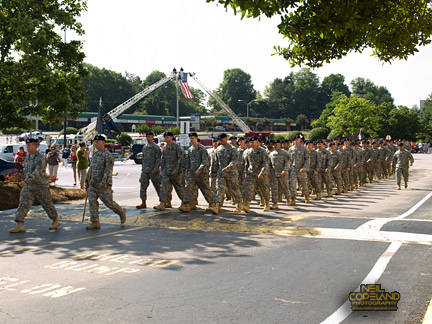 Charlie Co. arrives after passing under Old Glory